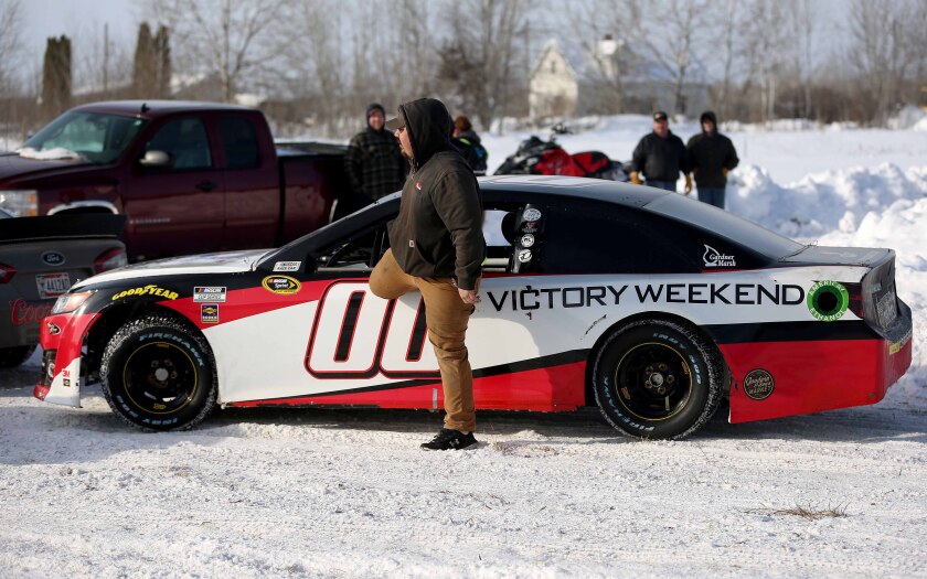 Brandon Olsen, of Poplar, exits a retired NASCAR Cup Series car that he drove