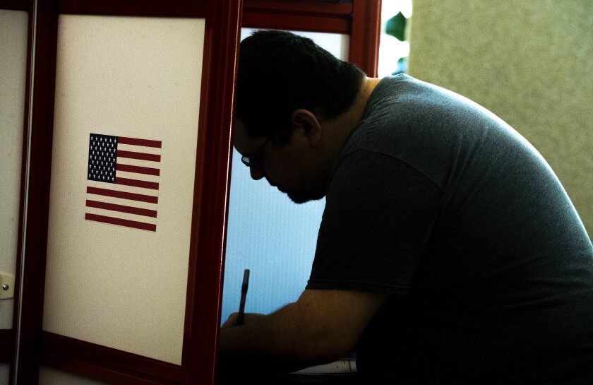 Jeremy Parker fills out his ballot at Vinje Lutheran Church during the primaries in Willmar on Tuesday, August 9, 2022.