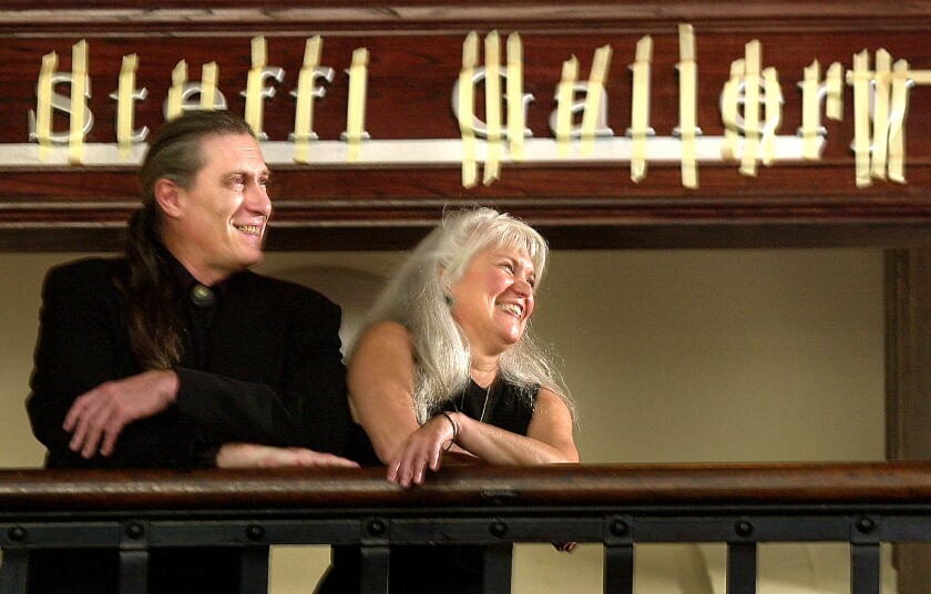 John Steffl (left) and Linda Hebenstreit stand in front of the newly erected sign on the Steffl Gallery at the Duluth Art Institute in 2002.