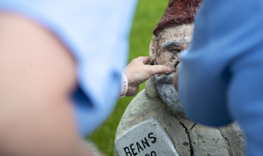 Jesi Martinson, at left, and Sharilyn Bates examine a gnome in the Dawson city park on Tuesday, May 31, 2022.