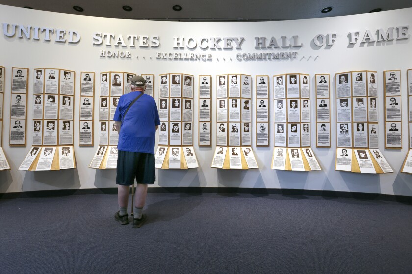Man touring the U.S. Hockey Hall of Fame.