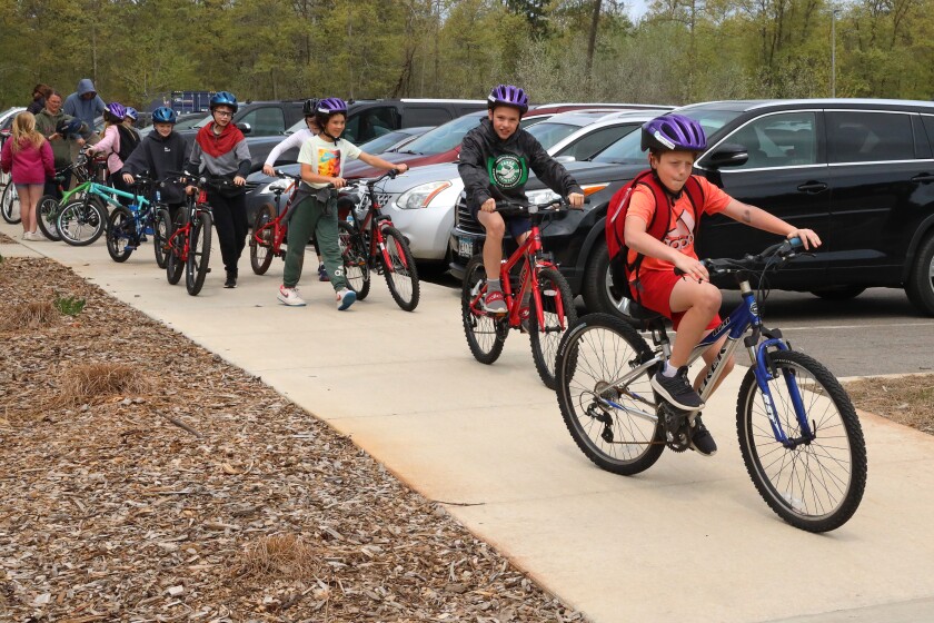 Students ride bike at Baxter school.
