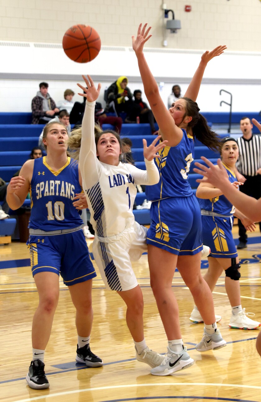 Minnesota West Lady Jays MacKensie Post (1) dives between Minnesota State Fergus Falls Spartans Emily Dehler (10) and Lindsey Kurz (3) for two points Monday evening in Worthington.