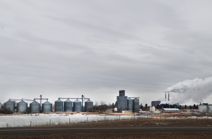 The skyline of Falkirk, ND is flanked by smoke from a coal-fired electrical generation plant, associated with the Blue Flint Ethanol plant.