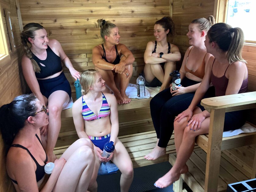 People sitting inside of a sauna