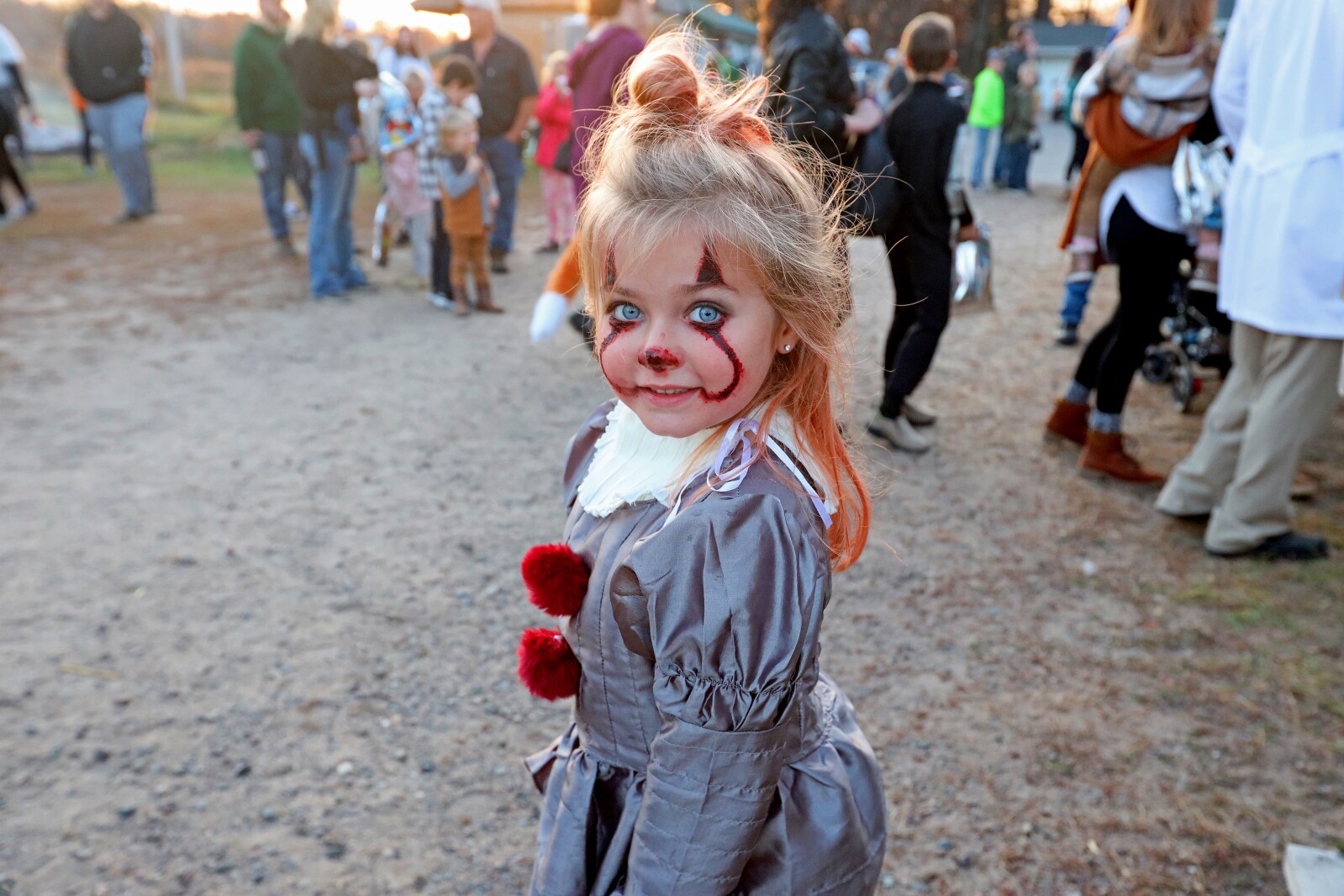 Little girl in a scary clown costume.