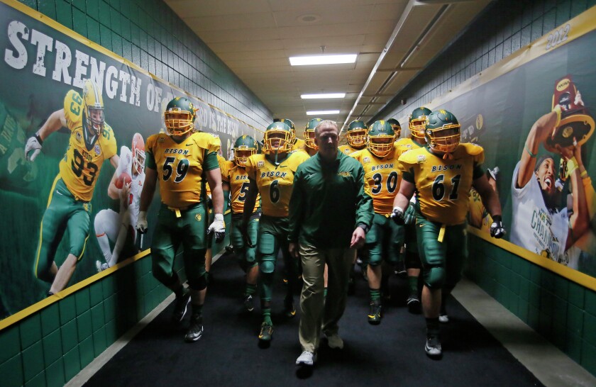 NDSU head coach Chris Klieman and his seniors lead the team out of the locker room to take the field against Western Illinois last Saturday wearing their new green harvest helmets. Even though it was my day off, this was a shot I had to have, you just had the feeling they were amped up and ready to go. Especially watching Brian Schaetz on the walk through, he was a caged grizzly ready to let loose. David Samson / The Forum