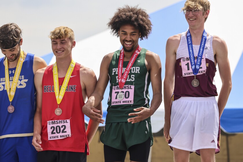 High school athletes compete in track and field events at outdoor stadium