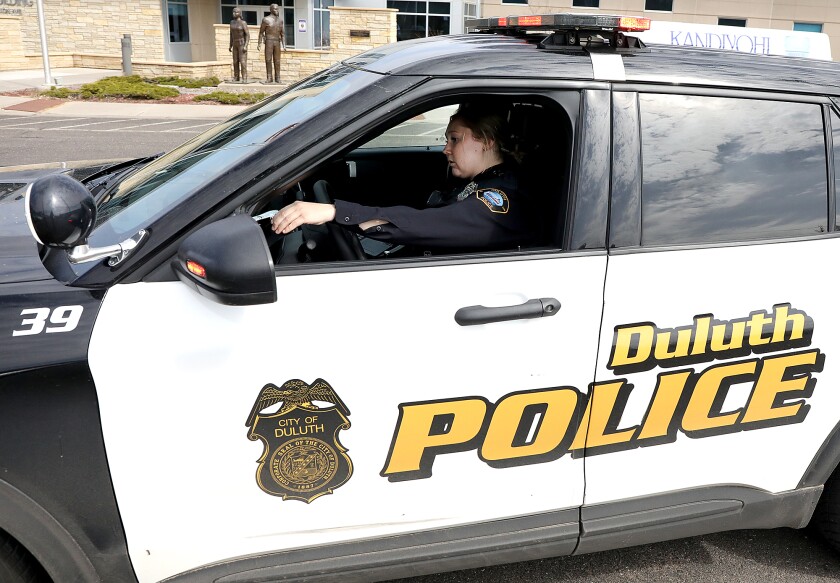 New Duluth Police Officer Katie Catton checks the lights in her squad car