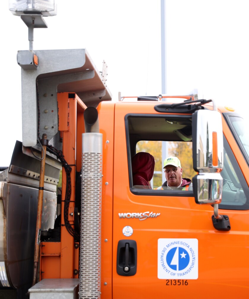 A Minnesota Department of Transportation driver instructs a student on the snow blade controls of a snowplow at the Career Expo at Minnesota West Community and Technical College Tuesday, Oct. 4, 2022.