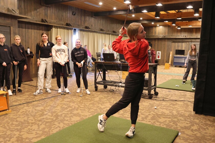 Madi Holstrom practices her swing during golf practice on Wednesday, April 9, 2025, at Madden's Resort.