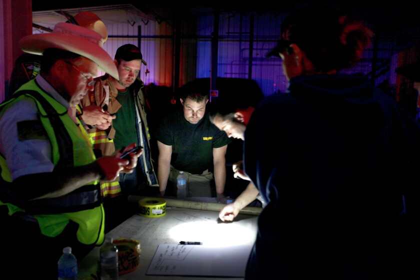 From left, Sanborn County Sheriff Tom Fridley, Wessington Springs firefighter Dustin Weber, Jerauld County Sheriff Jason Weber and Jerauld County Deputy Sheriff Shane Mentzer check off locations on a map June 18 at the command center inside the Wessington Springs Fire Hall after a tornado hit the community. (Sean Ryan/The Daily Republic)