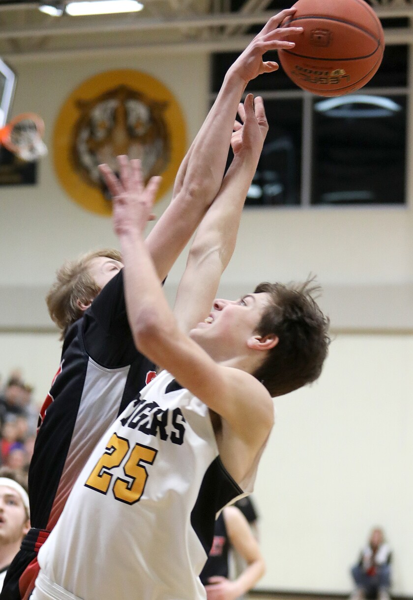Northwestern’s Bryce Oswskey (25) gets swatted by Somerset’s Kane Donnelly (15)
