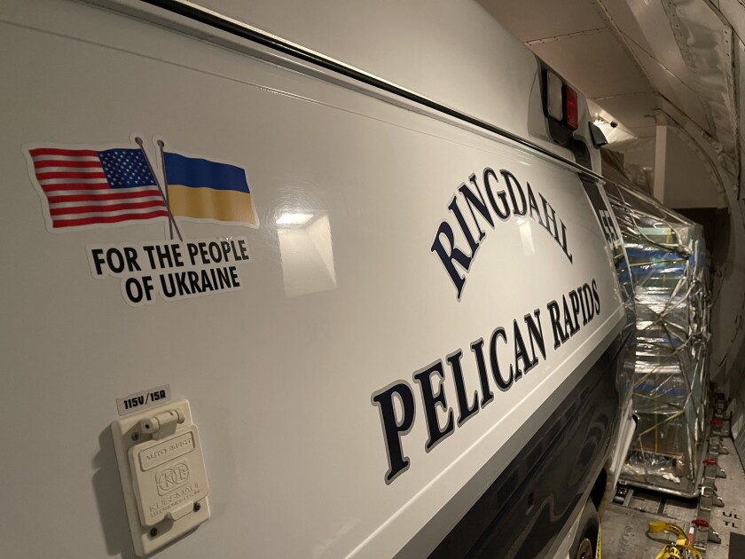 An ambulance that reads "Ringdahl Pelican Rapids" is packed among cargo.