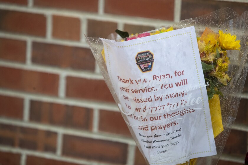 Flowers for the late Ryan Leif Erickson sit outside the Blomkest Fire Department on Tuesday, May 17, 2022.