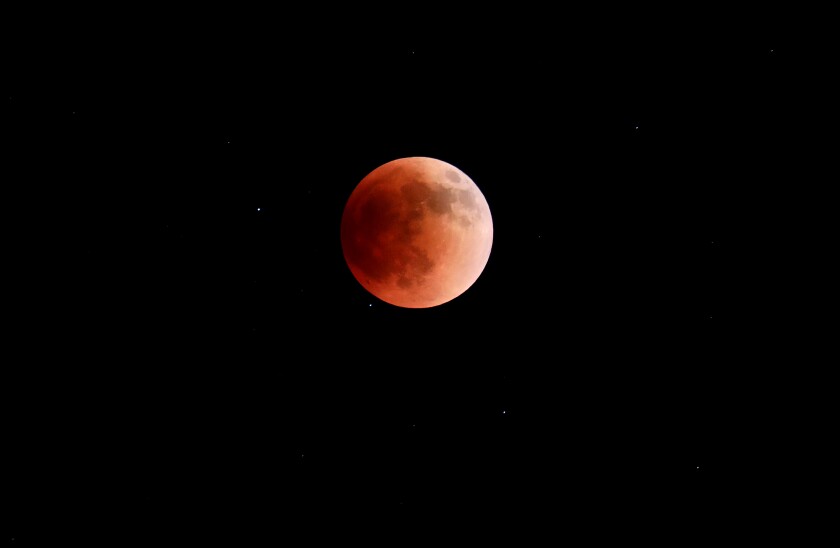 A total lunar eclipse turns the moon red Sunday, May 15, 2022, in Brainerd.