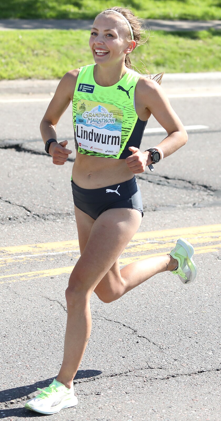 Dakotah Lindwurm runs along London Road with a huge smile on her face on her way to winning a second straight women's title