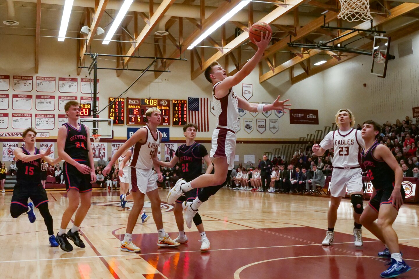 Davies' Mason Klabo sets the all-time North Dakota Division AA/A boys state scoring record on this layup against West Fargo Sheyenne on Tuesday, Feb. 18, Feb. 18, 2025, at Davies High School. Basketball player jumping with the ball in his hand towards the basket while other players are around him.