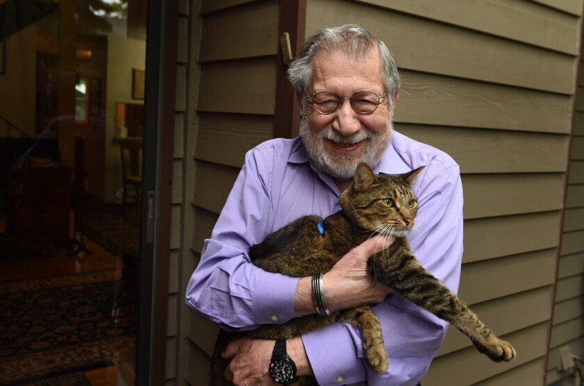Fred Amram, an 85-year-old former University of Minnesota professor who fled Germany with his parents as a child, will be re-naturalized as a German citizen Tuesday. Amram's family and other Jews were stripped of their ciitizenship in Nazi Germany in 1935. Amram is holding his cat Medele. Scott Takushi / St. Paul Pioneer Press