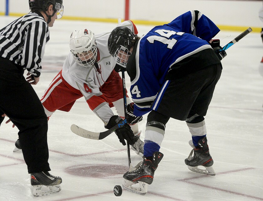 Willmar's Trenton Larson, 4, and Morris/Benson Area's Trevor Buss battle for the puck on the faceoff during a non-conference game Thursday, Jan. 13, 2022 at the Willmar Civic Center.