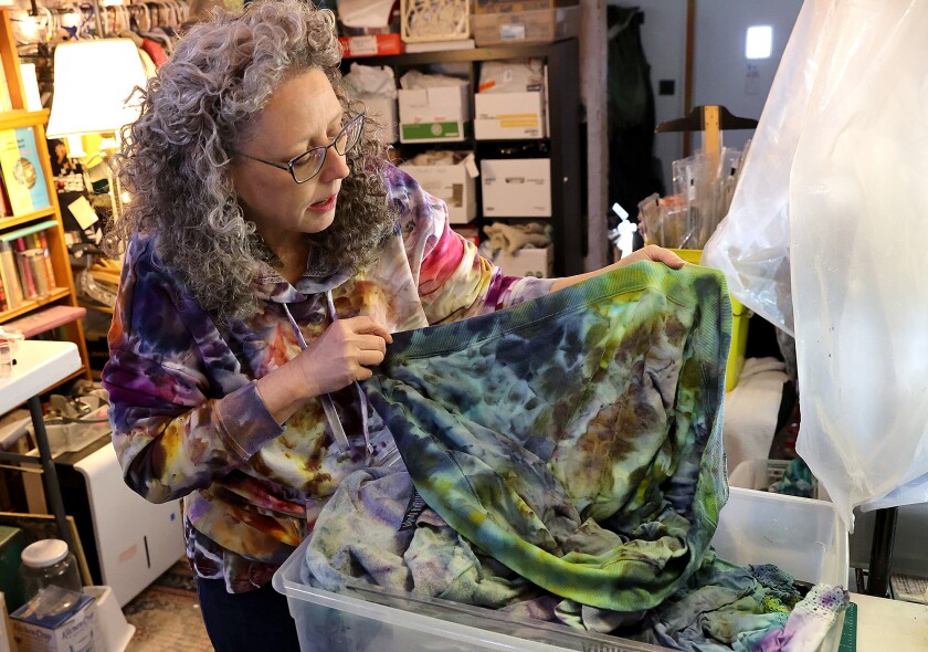 Woman checks dye.