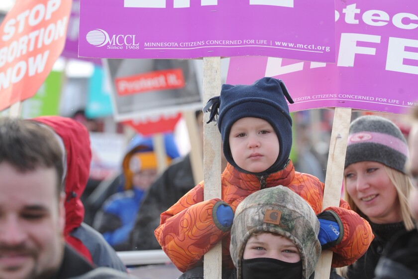 Kenny Heintzeman carries his brother Ryan Friday during the 43rd Annual Crow Wing Chapter of Minnesota Concerned for Life March marking the Roe v. Wade decision. The group marched north on South Sixth Street to the Historic Crow Wing Courthouse for a 2016 ceremony. (Brainerd Dispatch/ Steve Kohls)
