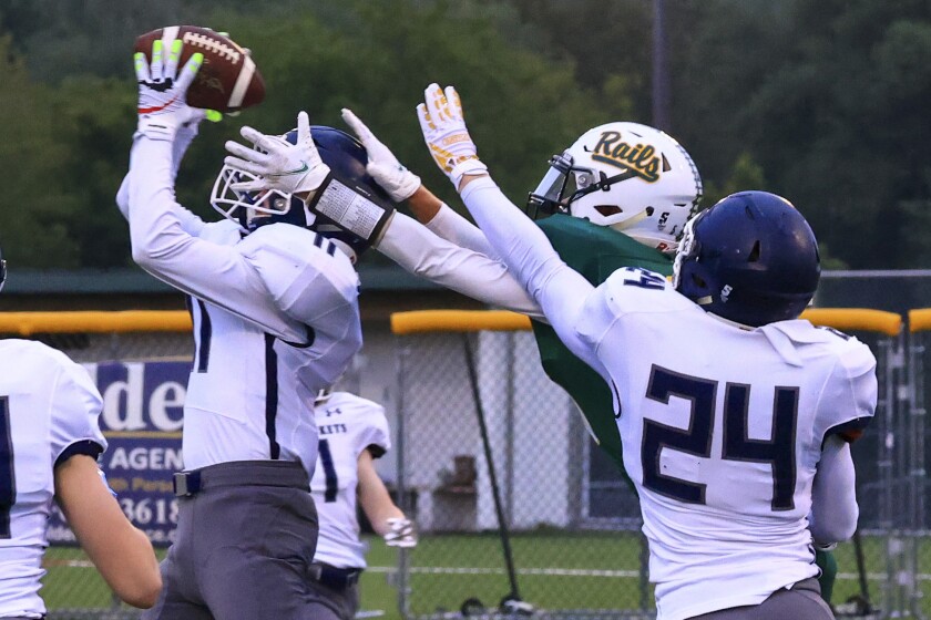 Football players and fans at outdoor high school game