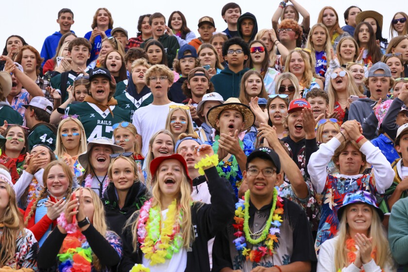 Football players and fans at outdoor high school game