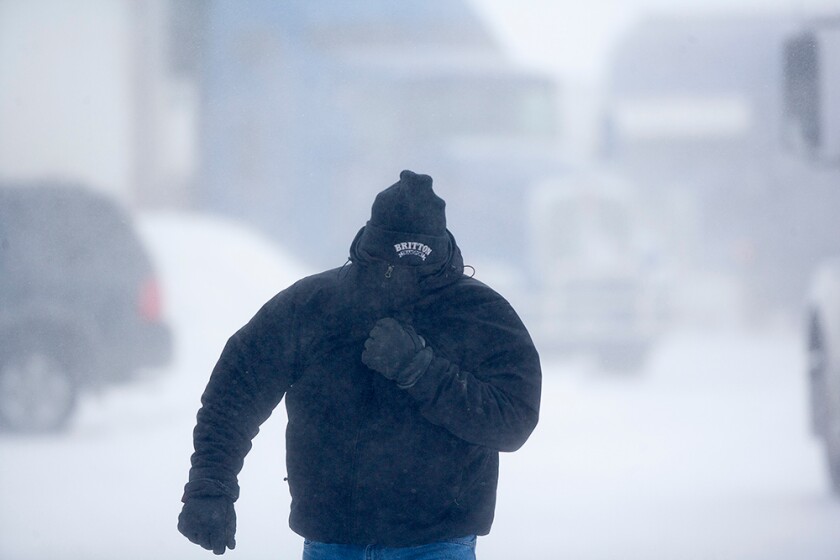 Duane Wages faces a stiff north wind during a blizzard in this undated photo. (Eric Hylden/Grand Forks Herald)