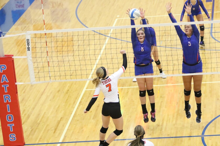 Patriots Sannah Lohmiller and Elle Olmscheid block a hit by Tigers Anna Felthous Thursday, Sept. 7.