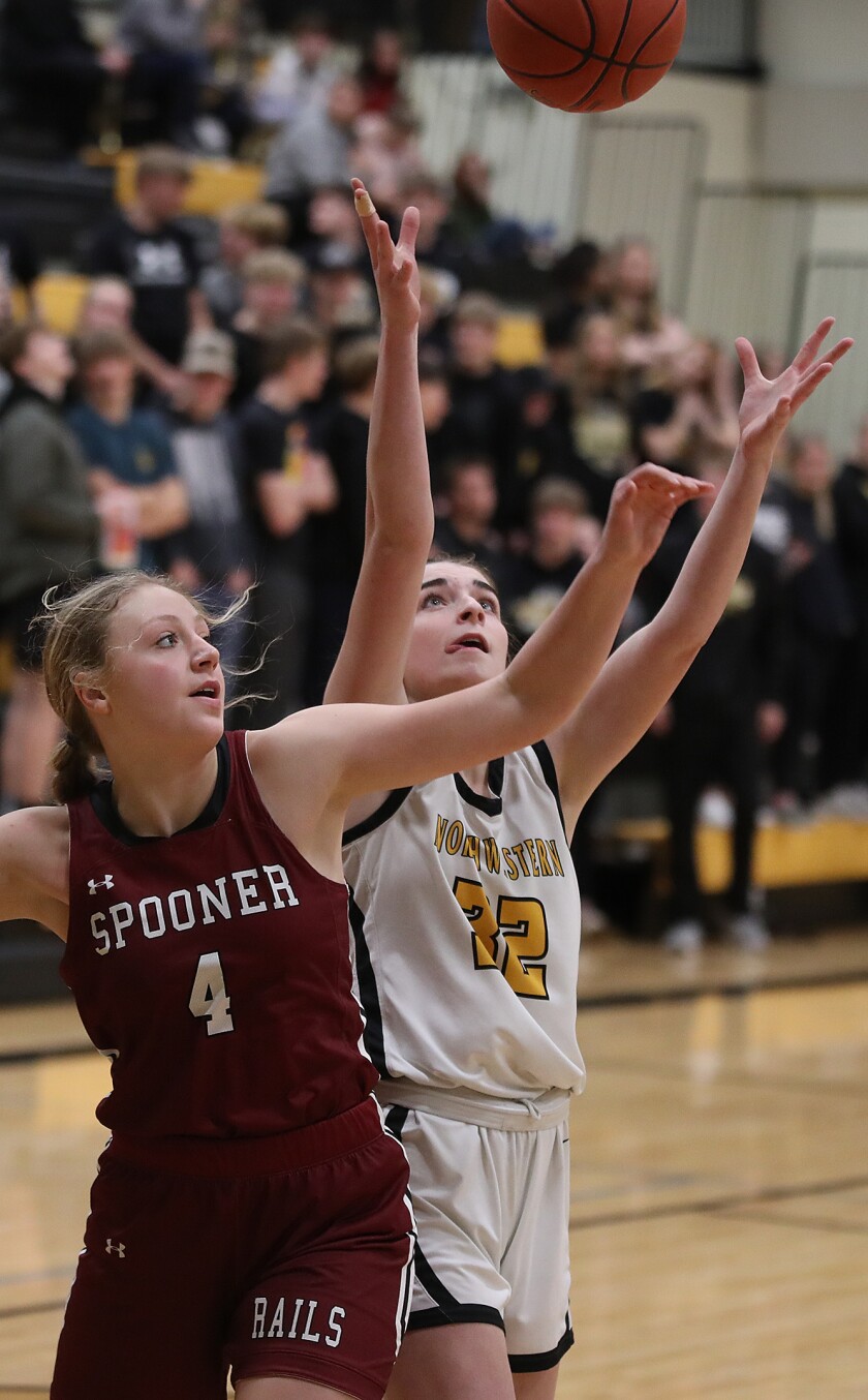 Northwestern’s Abby Johnson (32) grabs a rebound over Spooner’s Lily Hotchkiss (4)