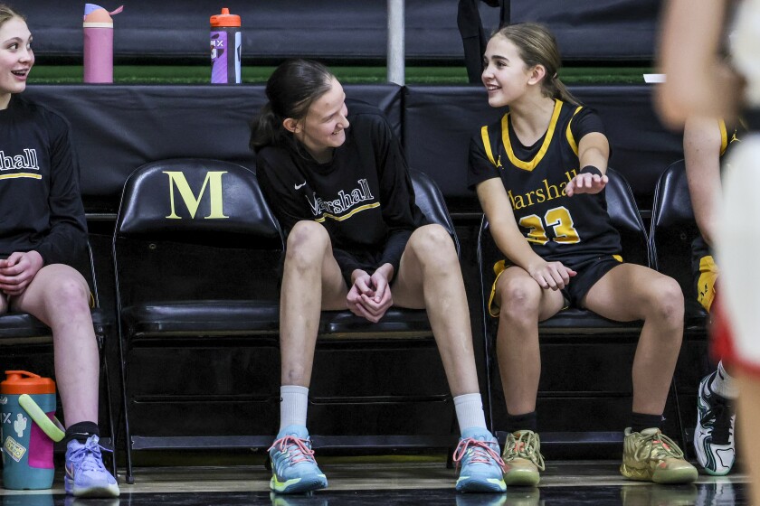 high school girls play basketball