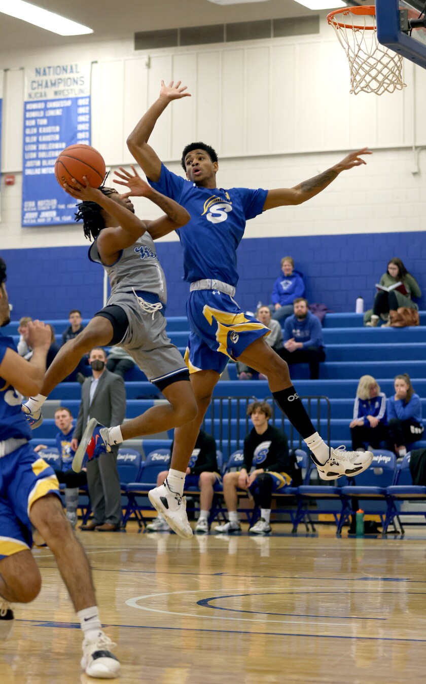 Minnesota West Blue Jays CJ Ligon (1) leaps up to make two points on a fast break past Minnesota State Fergus Falls Spartans Langston Monday evening in Worthington.