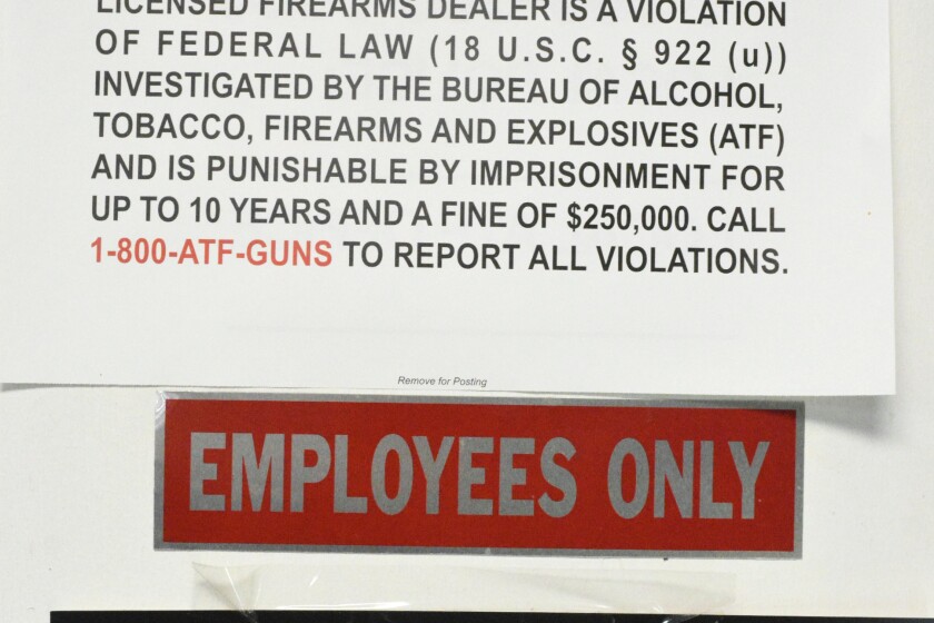 A sign posted at Viking Pawn spells out the consequences for stealing firearms.