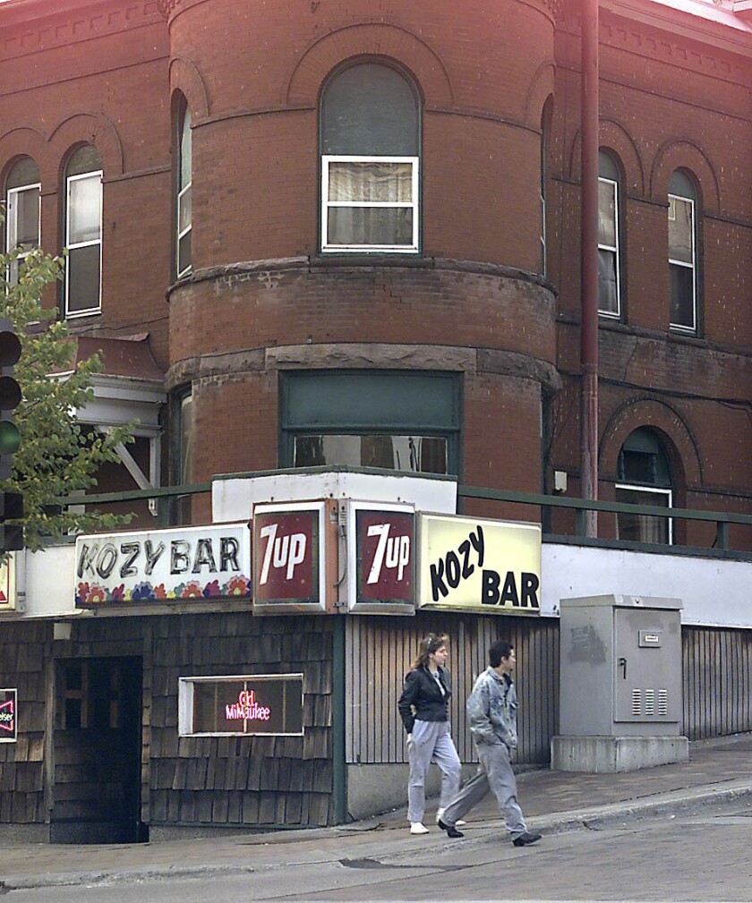 People walk by the Kozy Bar in 1997.