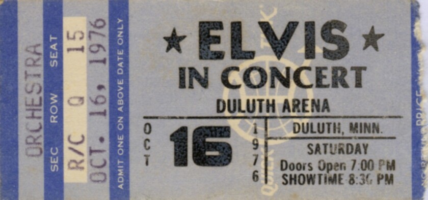 A ticket stub in tones of blue and white, reading ELVIS IN CONCERT / DULUTH ARENA / OCT 16 1976.