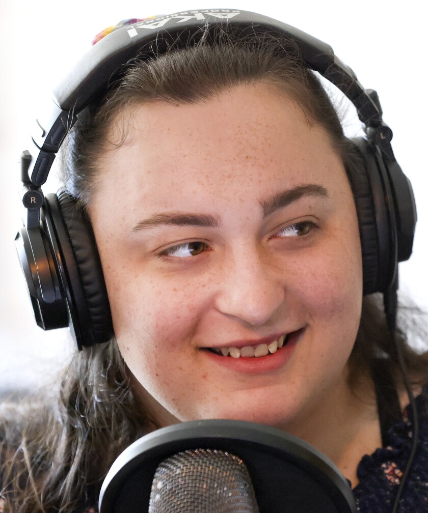 Woman talking into a mic.