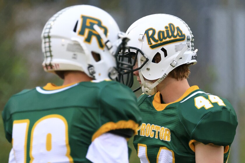 Football players and fans at outdoor high school game