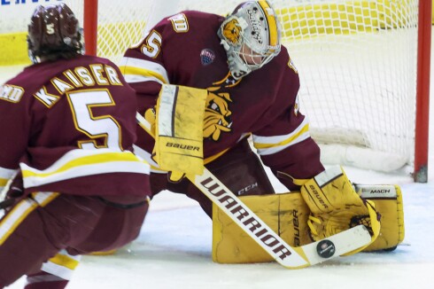 college men play ice hockey