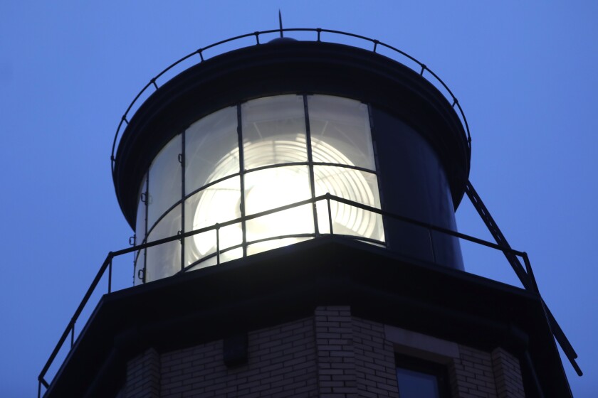 A lit beacon of a lighthouse during a ceremony.