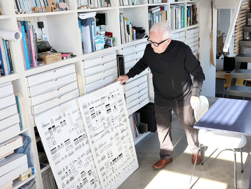 Man looks at drawings.