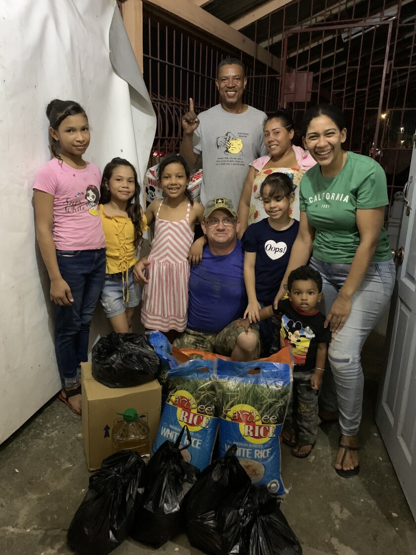 Guyana_Joseph with some of the children and adults helping to distribute the food to refugees.jpeg