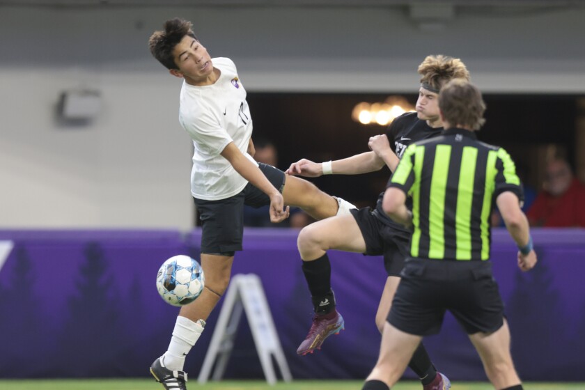 boys soccer players playing in indoor stadium