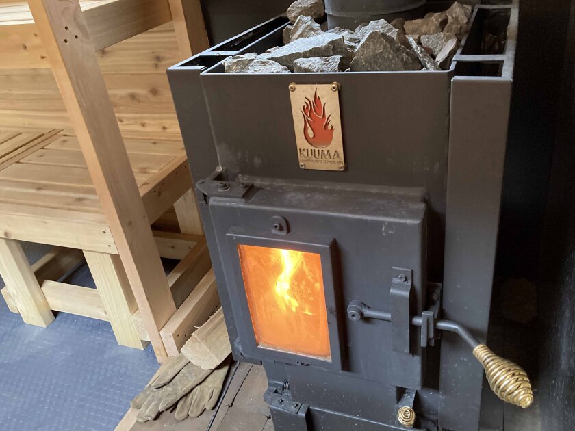 A burning stove inside of a mobile sauna