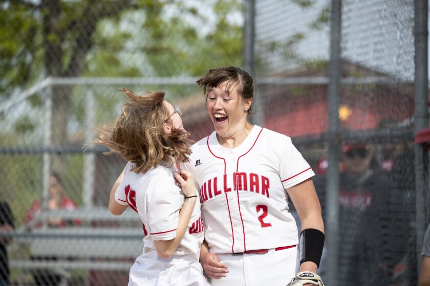 Willmar High School sophomore Kylie Porttiin chest bumps senior Luly Reed as the starting lineup is announced during a Section 8AAA playoff game against Sauk Rapids in Willmar on Tuesday, May 24, 2022.