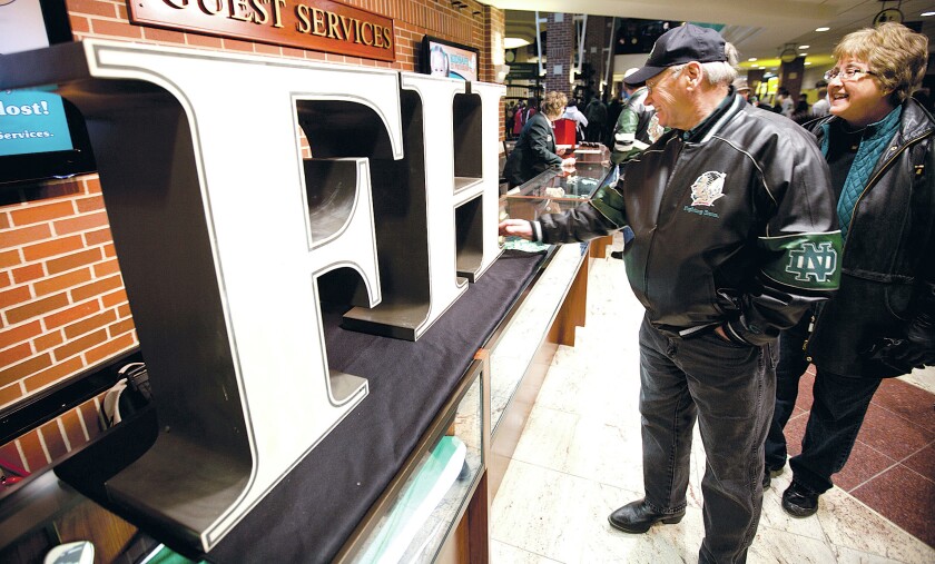 UND fans Kent and Val Krogstad of Hatton check out letters from the Home of the Fighting Sioux slogan