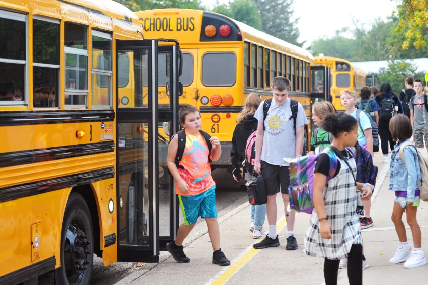 Students getting off school buses