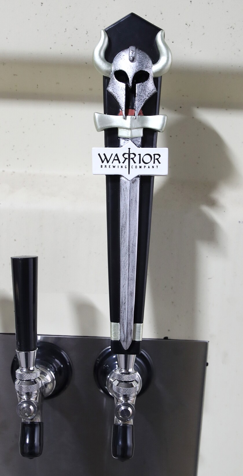 A Warrior Brewing Company tapper is attached to the cooler