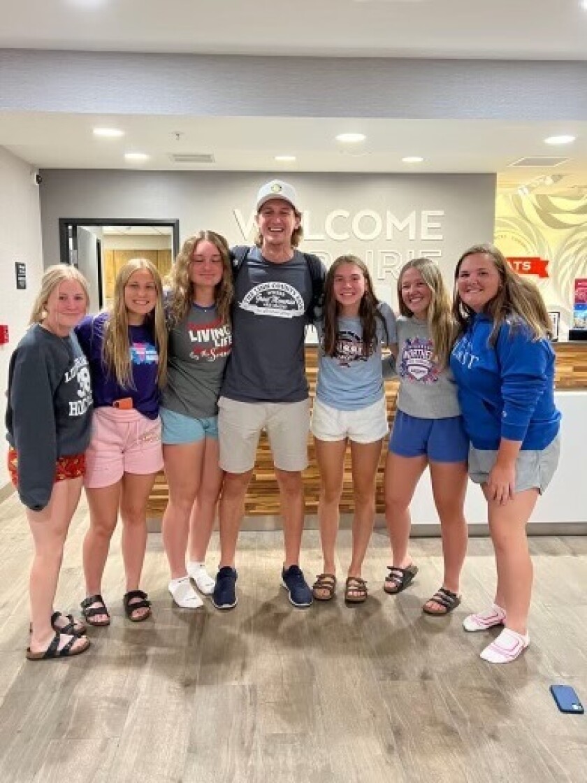 Players pose for picture with artist