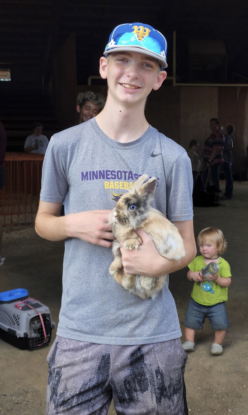 A participant in the 4-H Pet Show holds his rabbit Wednesday, Aug. 10, 2022, at the Jesse Oleson Pavilion during the Cottonwood County Fair.